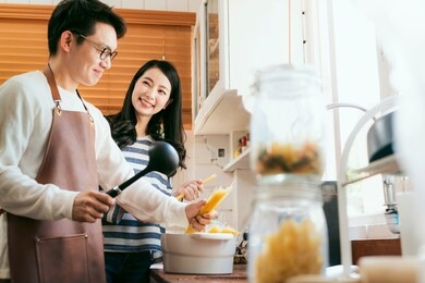 attractive asian couple marry family  preparing cooking food dinner together with happiness and freshful in home kitchen family ideas concept