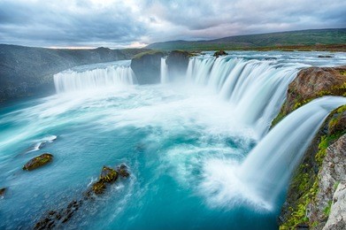 godafoss is a very beautiful icelandic waterfall. it is located on the north of the island not far from the lake myvatn and the ring road. this photo is taken after the midnight sunset
