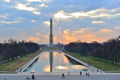 the george washington monument and reflecting pool at sunrise in washington dc, united states