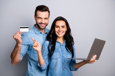 close up photo beautiful amazing she her he him his couple lady guy hold credit card notebook show simple way internet buy pay  wear casual jeans denim shirts outfit clothes isolated grey background