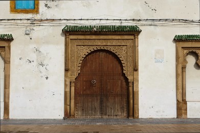 large rustic wooden moorish style double door in essaouira, morocco