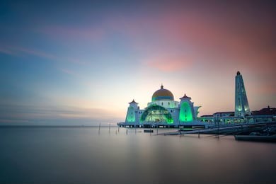 malacca straits mosque ( masjid selat melaka), it is a mosque located on the man-made malacca island near malacca town, malaysia in sunset and blue hour view.