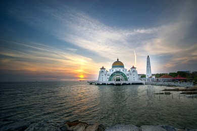 malacca straits mosque ( masjid selat melaka), it is a mosque located on the man-made malacca island near malacca town, malaysia in sunset and blue hour view.