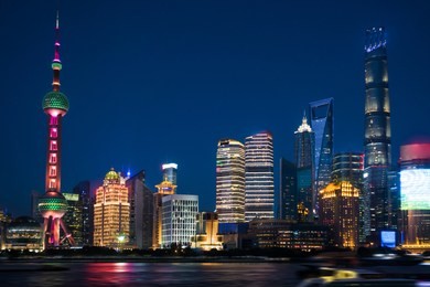 shanghai, china - jun 21 , 2018 :nightscape of lujiazui skyline as seen from the bund, across the huangpu. zoom to across the night view. night panorama of beautiful shanghai city with bright lights,