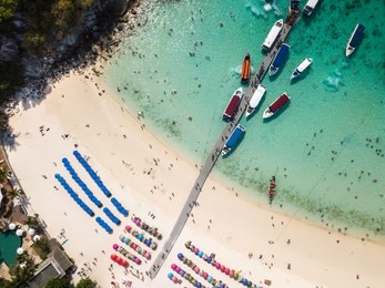aerial of cabin cruiser and speedboath on the big ocean in andaman at koh racha yai, tourism sunbathe, swiming and playing games on the beach, phuket, thailand (photo from drone)