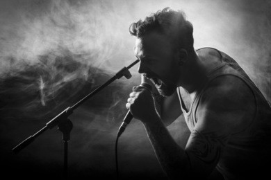 young man sing / growls in hard rock concert.