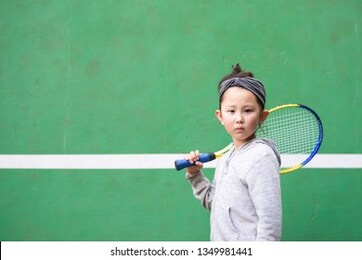 girl practicing tennis