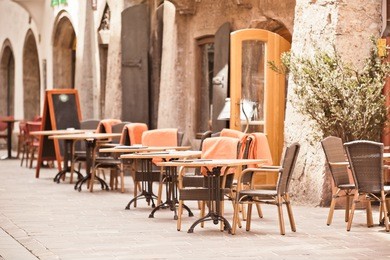 outdoor street cafe tables ready for service. small grip toned shot