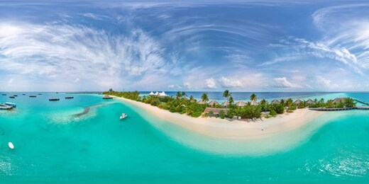 aerial spherical panorama of tropical paradise beach  on tiny maldives island. turquoise ocean and white sand. small bungalows between coconut palm trees