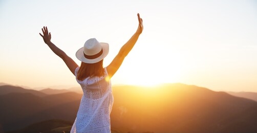 happy girl enjoying nature at sunset in summer