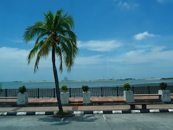 strait of malacca with a walkway next to the river in malacca, malaysia.