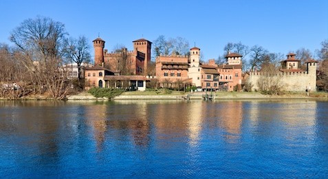 medieval fortress in valentino park, turin, piedmont, italy, bright blue sky spring morning on the po river
