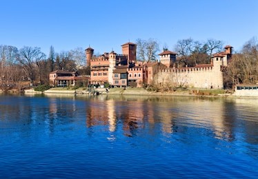 medieval fortress in valentino park, turin, piedmont, italy, bright blue sky spring morning on the po river