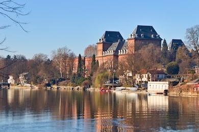 valentino castle in the valentino park on the po river, turin, piedmont, italy, bright blue sky spring morning