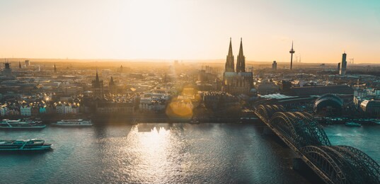 panoramic view of cologne, germany, with cologne cathedral, hohenzollern bridge and old town at sunset