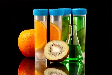 lb tubes filed with liquid of with fruits parts on black background.