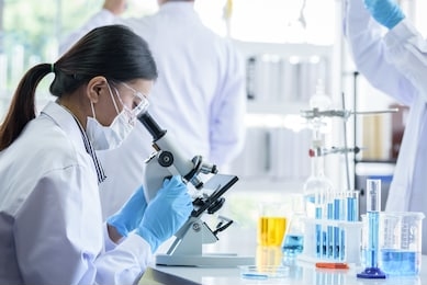 asian scientist team has researching in laboratory.