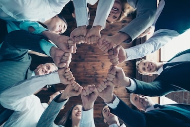 close up low angle view photo members business people circle she her he him his hold hands arms fists together celebrate project prize nomination power inspiration dressed formal wear jackets shirts