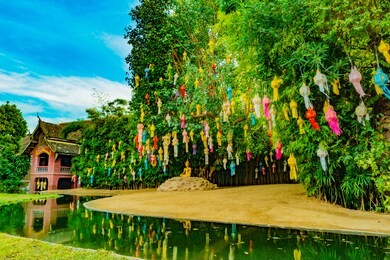 colorful lanterns on green tree in buddhist temple wat phan tao, chiang mai, thailand