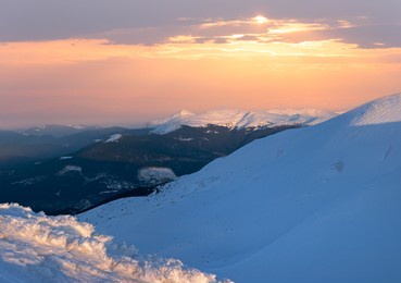 winter mountain ridge view in last evening sunrays (ukraine, carpathian).