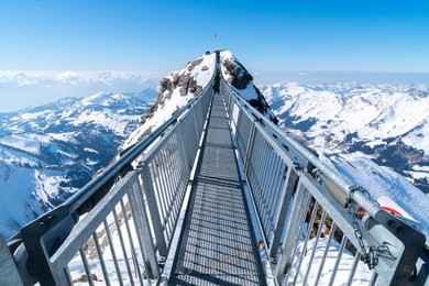 a breathtaking bridge above the sky_"the titlis cliff walk" is a pedestrian bridge along the cliff of mount titlis in the swiss alps. built at around 10,000 feet (3,000 m) above sea level. 