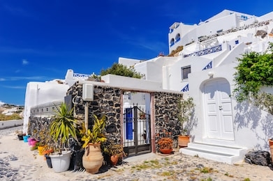 typical street view of fira village at santorini island, greece