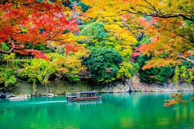 beautiful arashiyama river with maple leaf tree and boat around lake in autumn season kyoto japan