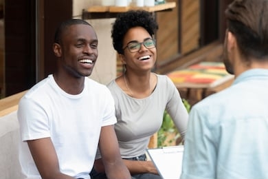 happy african american young family couple listen to counselor psychologist salesman realtor consult black clients talk to patients customers holding clipboard at meeting, marriage therapy counseling