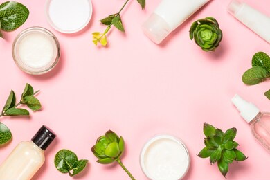 skin care product, natural cosmetic, flat lay image on pink background.