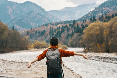 traveling woman tourist with a backpack on the back of the mountains vacation travel