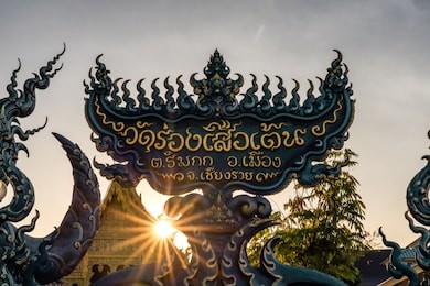 sign of wat rong seur ten or blue temple in  chiang rai thailand at sunrise ,thai language.