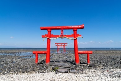 the floating torii gate of ouo shrine in ariake sea, tara town, saga prefecture, japan. (translated text: the god of the sea) 