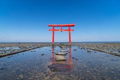 the floating torii gate of ouo shrine in ariake sea, tara town, saga prefecture, japan. (translated text: the god of the sea) 