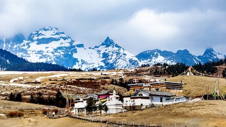 small stupa and tibetan monastety  in yak meadow, jade dragon snow mountain, lijiang china