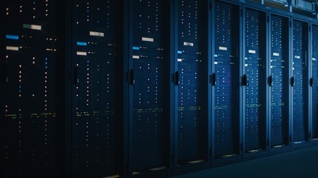 shot of dark data center with multiple rows of fully operational server racks. modern telecommunications, cloud computing, artificial intelligence, database, supercomputer.