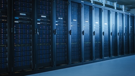 shot of modern data center with multiple rows of fully operational server racks. modern high-tech telecommunications database super computer in a room.