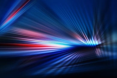 abstract dark background of light with stripes of colourful rays moving from the center