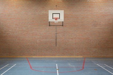 interior of a gym at school, jumping high at the basket