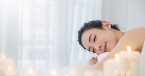 closeup beautiful asian young  woman lying down on massage beds at asian luxury spa and wellness center. portrait of beauty woman relaxing with copy space, healthcare lifestyle concept banner.