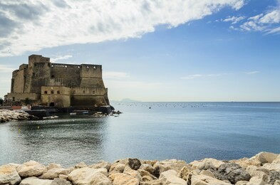 castel dell'ovo (in english, egg castle)  is a seaside castle in naples, located on the former island of megaride, now a peninsula, on the gulf of naples in italy.