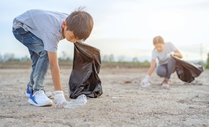 group of kids school volunteer charity environment, improving environment. kind eco-friendly volunteers holding packets and gathering garbage 