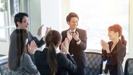 group of people clapping their hands.