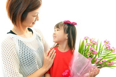 joyful little girl holding flowers in hand