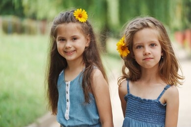 photo of two little girls in summer park