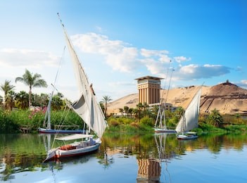 river nile and boats at sunset in aswan