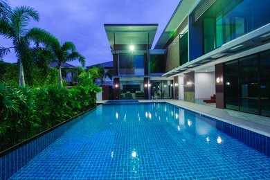 modern house with swimming pool at night