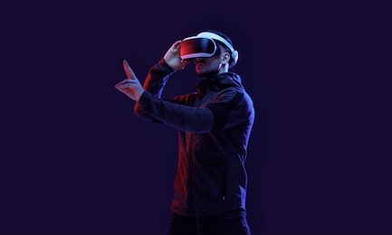 model young man with beard in glasses of virtual reality on dark background.. augmented reality, science, future technology concept. vr. futuristic 3d glasses with virtual projection. neon light.