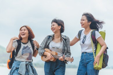 asian friends walking in camping and nature background, backpack, travel and adventurous concep