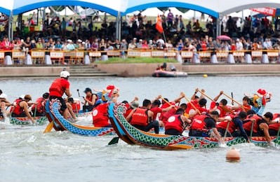 scene of competitive boats racing in the traditional dragon boat festival in taipei, taiwan 