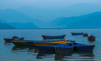 colorful boats in phewa lake in pokhara, nepal